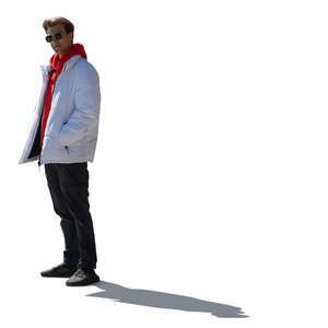 backlit young man wearing a white bomber jacket standing