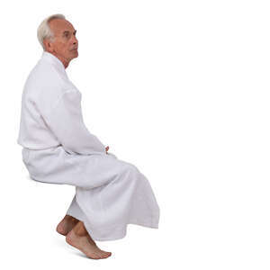 cut out older man in a white spa bathrobe sitting