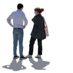 two backlit people standing