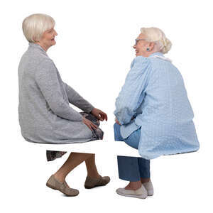 two older grey haired women sitting and talking