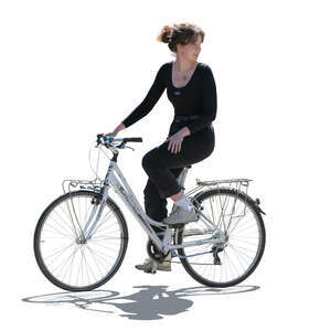 backlit woman riding a bike and looking back over her shoulder