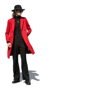 young man wearing a red overcoat and a black hat standing