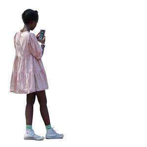 black teenage girl in a pink dress standing