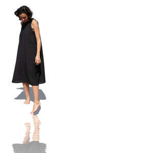 cut out woman in a black dress touching pool water with her leg