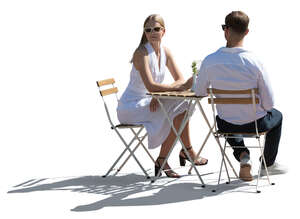 backlit elegant couple sitting in a restaurant