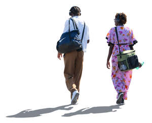 two backlit black people walking