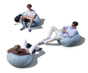 top view of three boys sittig outside in bean bag chairs