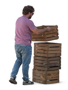 man lifting wooden boxes on top of each other