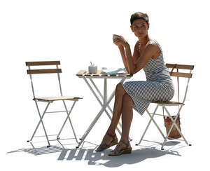 cut out backlit woman sitting in a cafe and drinking coffee