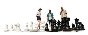 three people playing giant outdoor chess