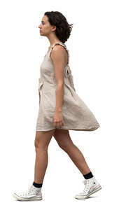 cut out woman in a beige mini dress walking