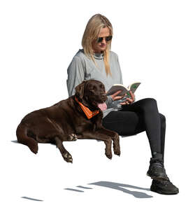 woman with a dog sitting and reading a book