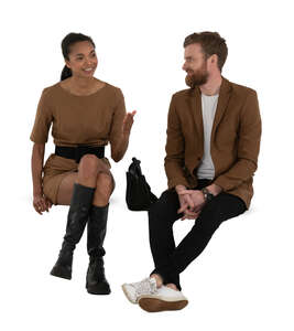 two cut out people sitting and having a conversation