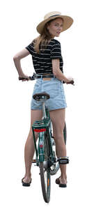 woman with a hat and a bike standing and looking back