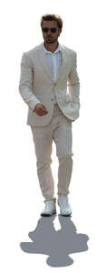 cut out backlit man in a white suit walking