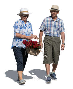 elderly couple with a basket full of flowers walking