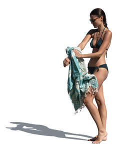 woman at the beach drying herself after swimming