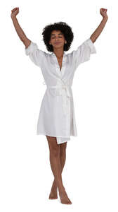 woman in a silky bathrobe walking and stretching her arms