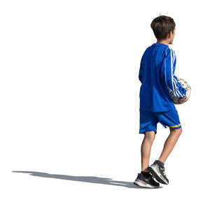 little boy with a football walking