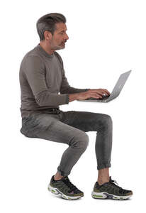 cut out man sitting and working with laptop