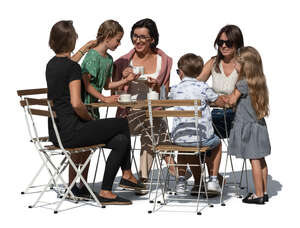 group of adults and children sitting in a cafe