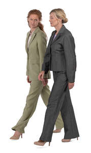 two women wearing business suits walking