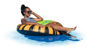 woman relaxing in a large floatie in the pool