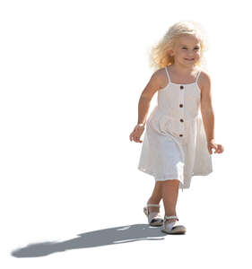 backlit little girl in a summer dress walking