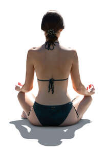 woman in a bikini doing yoga exercises