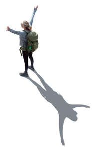 top view of a woman with hiking backpack standing arms up