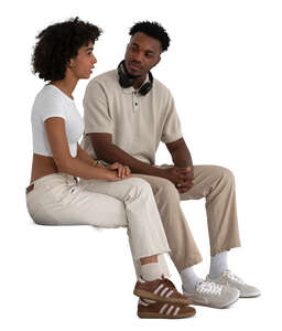 two black people sitting and talking