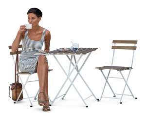 woman in a striped dress sitting in a cafe and drinking coffee