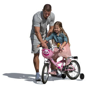 father helping her daughter ride a bicycle