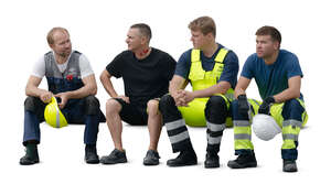 group of workmen sitting and resting