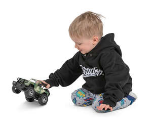 little boy playing with a toy truck