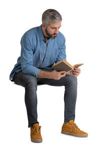 man sitting and reading a book