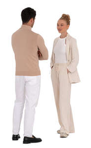 chic man and woman in white and beige coloured outfits standing