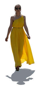 cut out backlit woman in a yellow dress walking