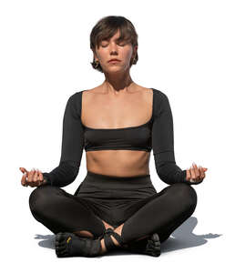 cut out woman sitting in a yoga pose outside