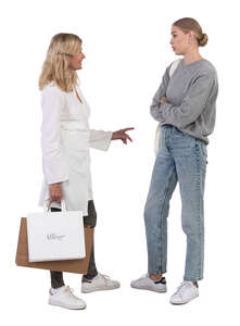 two women standing and talking while shopping