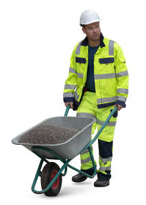 worker pushing a wheelbarrow full of gravel