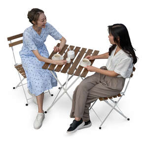 two cut out asian women sitting in a cafe seen from above