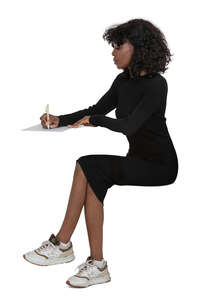 cut out woman in a black dress sitting at a desk and writing