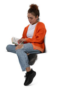 woman sitting on a sofa and reading a book