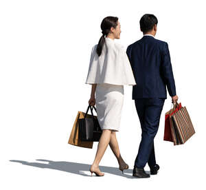 cut out asian couple with shopping bags walking