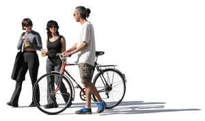 group of three friends walking in the street with a bike and soft drinks