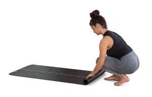 cut out woman rolling out an exercise mat