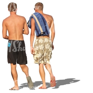 two men in shorts walking in the beach