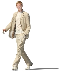 man in a beige suit walking