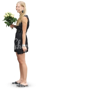 woman with flowers standing in a formal black dress